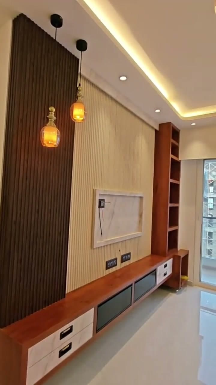 Living room media wall with wood panelling and pendant lights